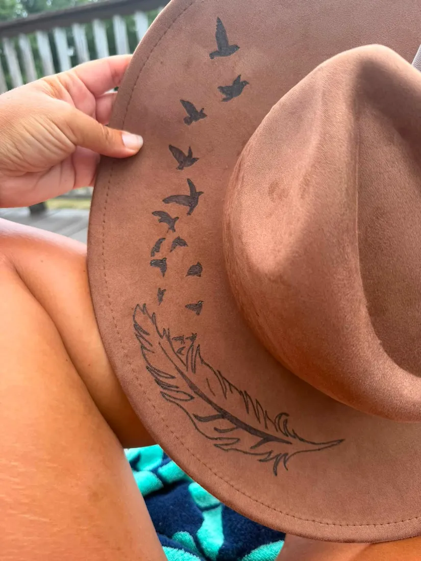 Bird and feather design hand-burned on a suede hat