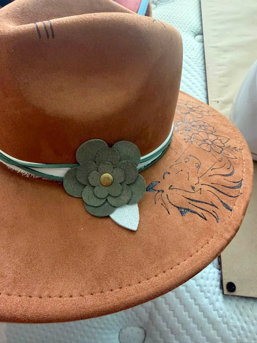 Floral design hand-burned on a brown suede hat