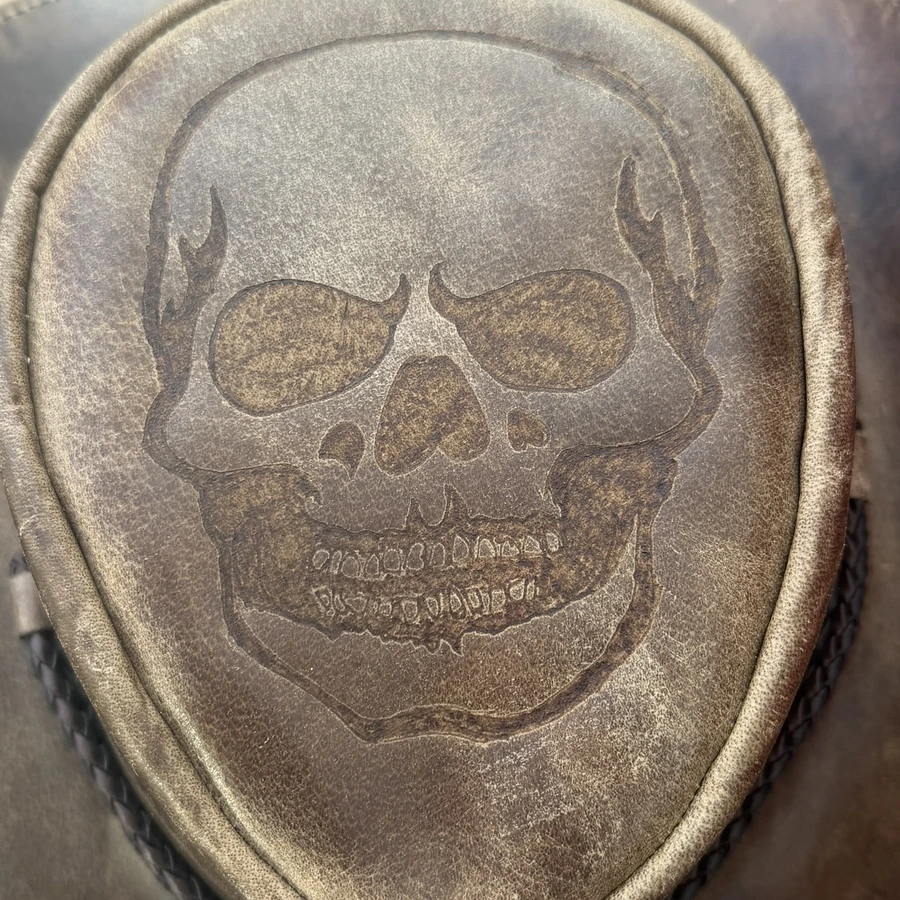 Skull hand-burned into a distressed leather hat crown